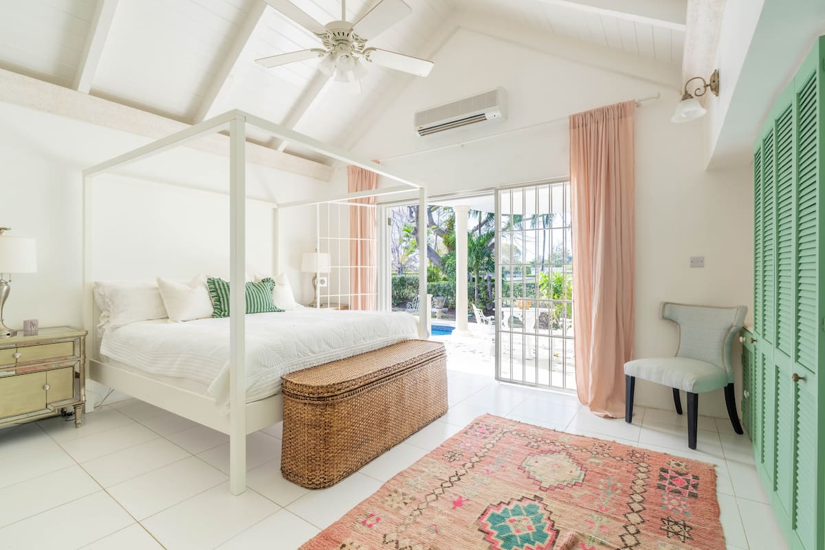 Airy primary bedroom opening onto a private covered terrace