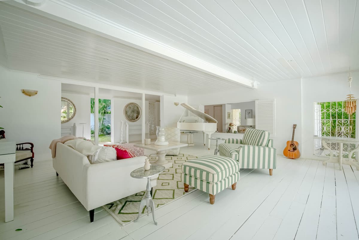 Bright veranda lounge with striped chairs